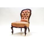 A Victorian button back nursing chair on cabriole legs,