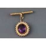 A Victorian yellow metal cluster pendant set with amethyst and seed pearls