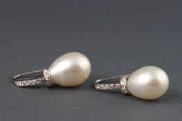 A pair of white metal cultured freshwater pearl and diamond drop earrings,