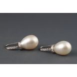 A pair of white metal cultured freshwater pearl and diamond drop earrings,