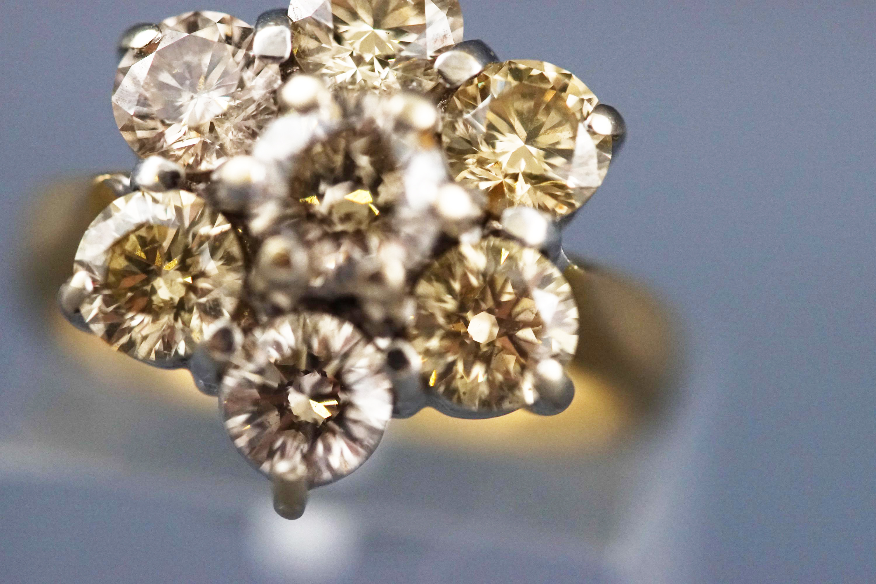 A yellow and white metal seven stone diamond flower ring, Estimated total weight of 2.50 carats. - Image 5 of 7