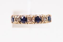A 9ct yellow gold seven stone sapphire and diamond ring. Hallmarked 9ct gold, Birmingham, 1975.