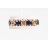 A 9ct yellow gold seven stone sapphire and diamond ring. Hallmarked 9ct gold, Birmingham, 1975.