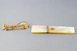 A mother of pearl toothpick holder with yellow gold and enamel embellishments together with.....