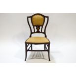 An Edwardian mahogany and marquetry saloon chair with boxwood stringing
