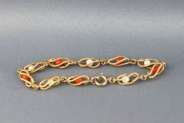 A yellow metal bracelet stylized as bead effect links encased with alternating coral and pearl beads