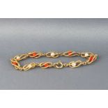 A yellow metal bracelet stylized as bead effect links encased with alternating coral and pearl beads