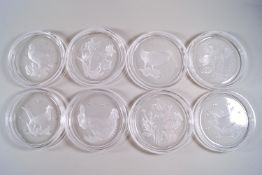 A set of eight Val Saint Lambert glass coasters, each moulded with either birds or flowers,