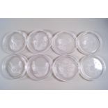 A set of eight Val Saint Lambert glass coasters, each moulded with either birds or flowers,