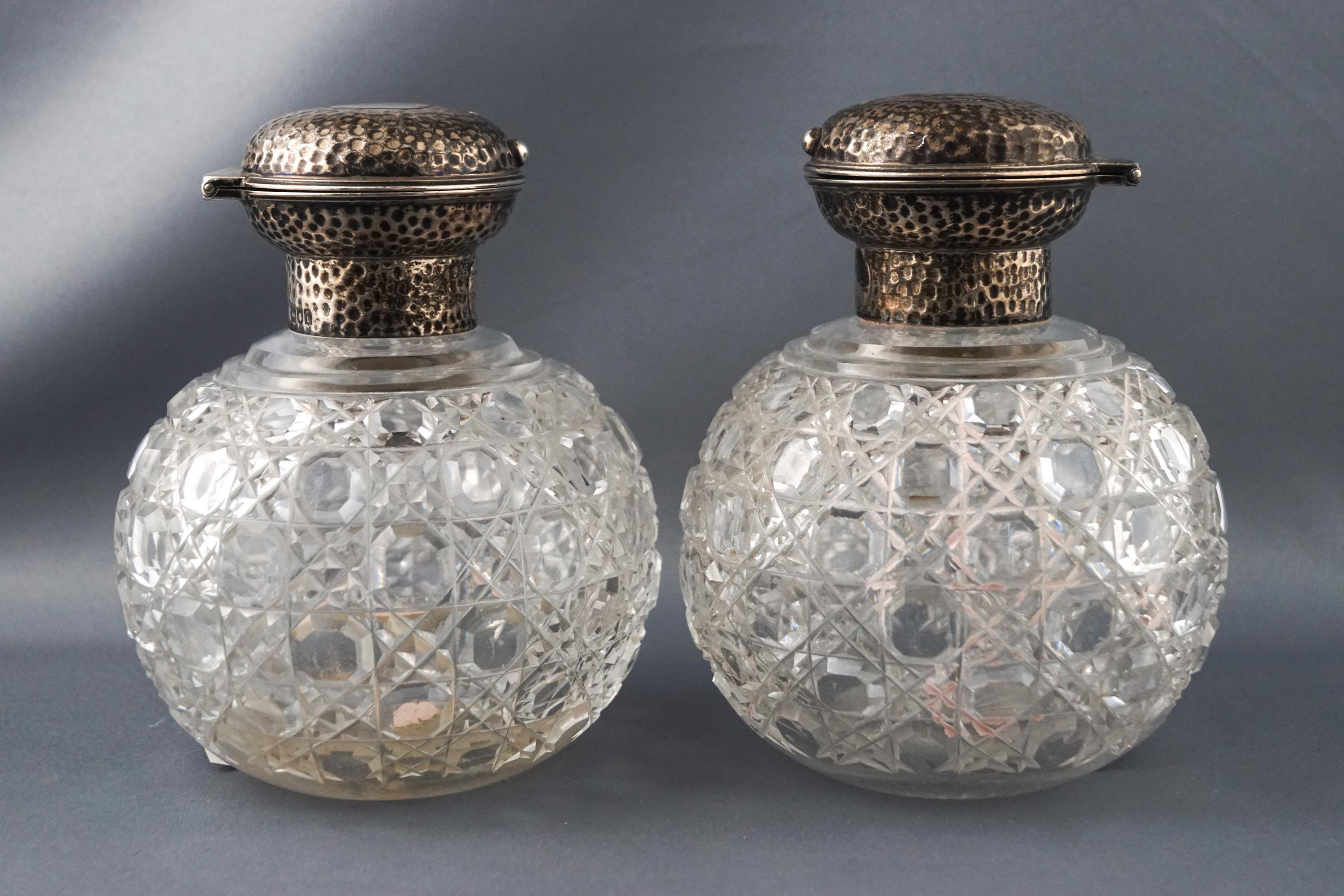 A pair of cut glass oversized scent bottles