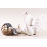 A Lladro figure of a swan and another of a duck and her duckling, with printed factory marks,
