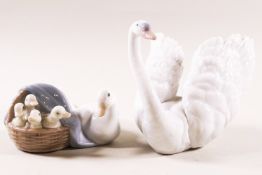 A Lladro figure of a swan and another of a duck and her duckling, with printed factory marks,