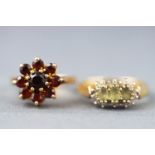 A collection of rings to include a green quartz and diamond cluster ring and a garnet cluster ring.