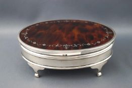 A silver and pique decorated tortoiseshell oval jewel casket, raised on four legs by Mappin & Webb,