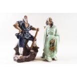 Two Chinese Shiwan (mud man) figures, one standing on a rocky base with an axe,
