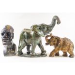 A green carved stone figure of an elephant, 25cm high, and a carved stone bust of an African man,