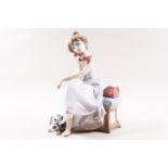 A Lladro figure group of a lady on a telephone with a dog at her feet, printed factory marks,
