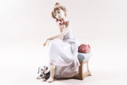 A Lladro figure group of a lady on a telephone with a dog at her feet, printed factory marks,