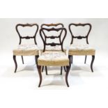 A set of four Victorian rosewood dining chairs with carved back rails
