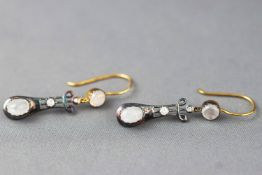 A pair of drop earrings set with moonstones and diamonds. Hook fitting.