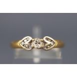 A yellow and white metal diamond ring with central oval brilliant diamond.
