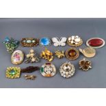 A selection of eighteen costume brooches of variable designs finished with enamel or paste stones