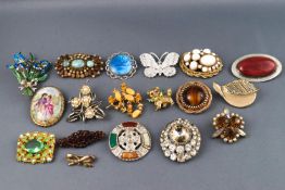 A selection of eighteen costume brooches of variable designs finished with enamel or paste stones