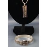 A hallmarked sterling silver ingot pendant suspended from a box link chain ......