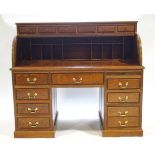 A contemporary mahogany bureau with six small drawers over a tambour top....