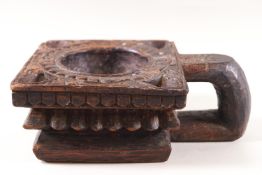 An Indian (possibly Rajasthan) square carved wood light holder with loop handle,