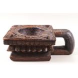 An Indian (possibly Rajasthan) square carved wood light holder with loop handle,