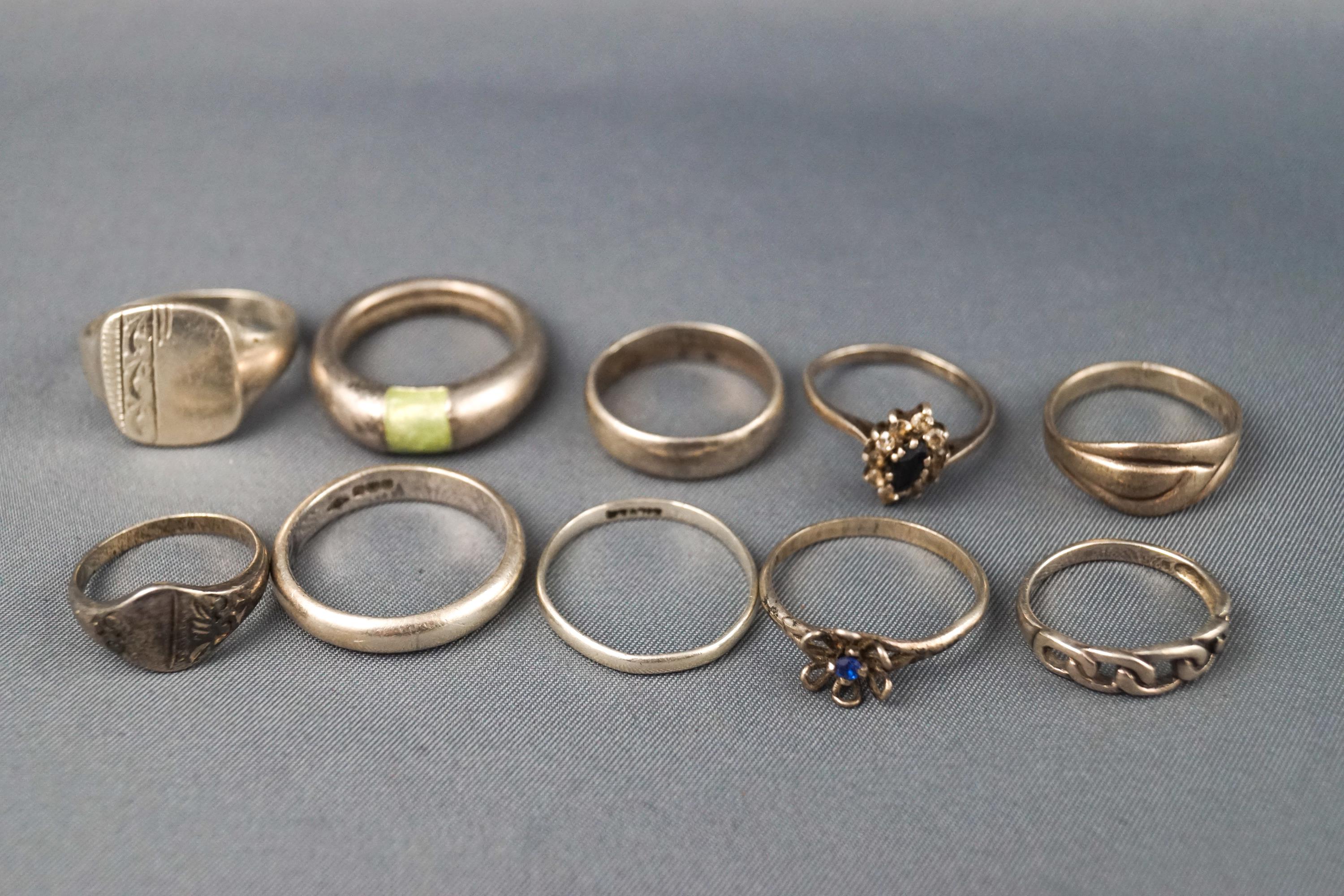 A collection of ten sterling silver rings consisting of plain bands, signet rings and some gem set.