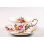 A Royal Worcester porcelain cup and saucer, printed and painted with flower sprays,
