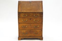 A Georgian oak bureau with fall front over lopers and four drawers with brass swan neck handles