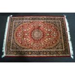 A beige ground Keshan carpet,