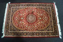 A beige ground Keshan carpet,