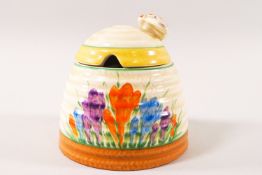 A Clarice Cliff Newport Pottery jam pot and cover in the form of a beehive,