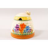 A Clarice Cliff Newport Pottery jam pot and cover in the form of a beehive,