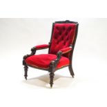 A Victorian armchair with mahogany show frame to the button back,