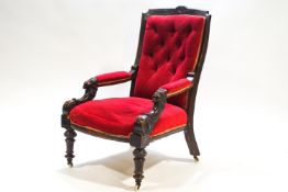 A Victorian armchair with mahogany show frame to the button back,