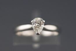 A white metal single stone ring set with a pear brilliant cut diamond. Supplied with an Anchorcert