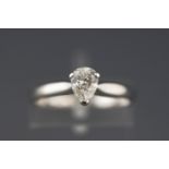 A white metal single stone ring set with a pear brilliant cut diamond. Supplied with an Anchorcert