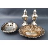 An oval silver pint tray/sweet meat dish, a shell shaped butter dish and a pair of baluster peppers