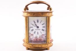 A 20th century carriage clock, of oval form, with enamel dial and side panels painted with Putti,
