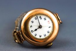 A yellow gold mechanical wristwatch with rolled gold expanding bracelet.