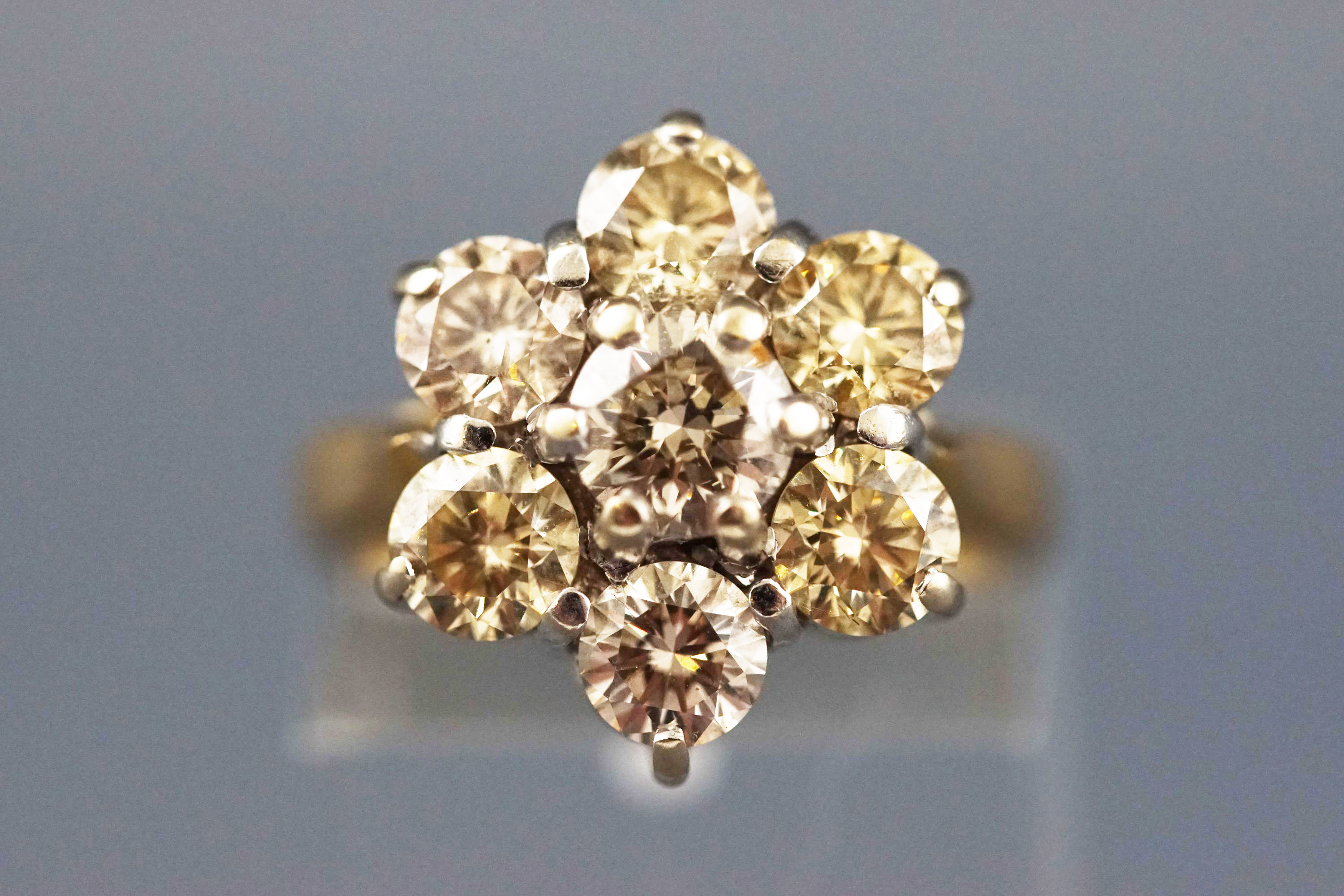 A yellow and white metal seven stone diamond flower ring, Estimated total weight of 2.50 carats. - Image 3 of 7