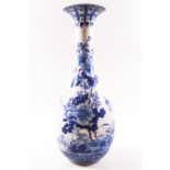 An early 20th century Chinese porcelain vase, painted in over glazed blue enamels with flowers,