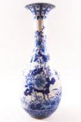 An early 20th century Chinese porcelain vase, painted in over glazed blue enamels with flowers,