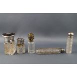 A cut glass scent bottle with a silver and tortoiseshell lid,