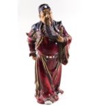 A Chinese Shiwan (mud man) figure with Sang de Boeuf glaze,